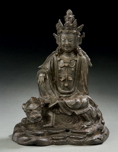 CHINE Brown patina bronze figure of the goddess Guanyin seated on a Buddhist lion...