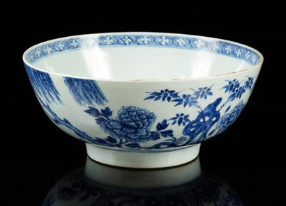 CHINE Large porcelain bowl of circular form decorated in blue underglaze with a landscape...