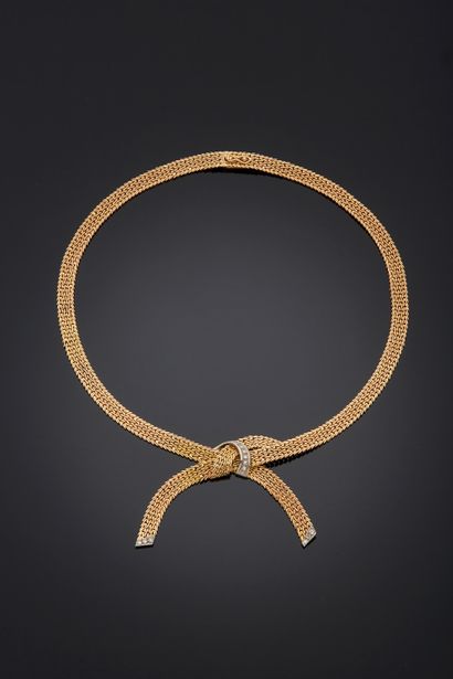 null NECKLACE in yellow gold 750 mm with flat articulated mesh, forming a cross knot...