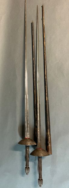 null Pair of dueling swords.

Iron mounting.

Fluted pommels, fluted spindles with...