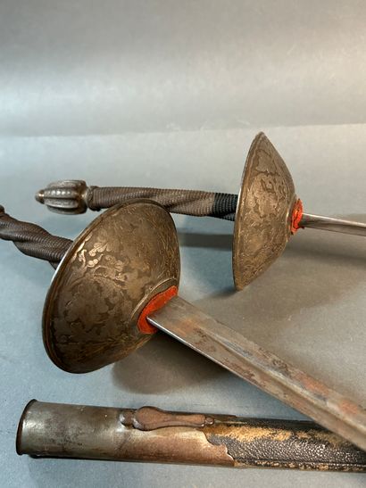 null Pair of dueling swords.

Iron mounting.

Fluted pommels, fluted spindles with...