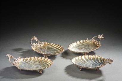 null Four cups in the form of shells in silver and vermeil, resting on three feet...