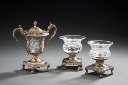 null Set composed of two salerons and a mustard pot in crystal and silver resting...