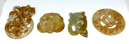 null CHINA
Lot of four jade plates carved and openworked in an archaic style.
Size...