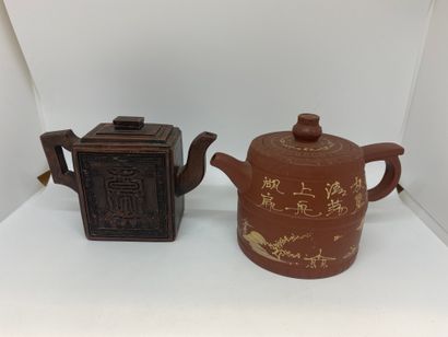 null CHINA
Two red stoneware teapots decorated with landscape and characters in relief.
Marks...