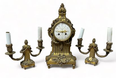 null Gilded and chased bronze mantel set consisting of a terminal clock and a pair...