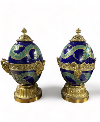 null Pair of earthenware egg-shaped incense burners decorated with green garlands...