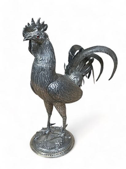 null Silver sculpture representing a rooster, the head forming a lid, the wings articulated....