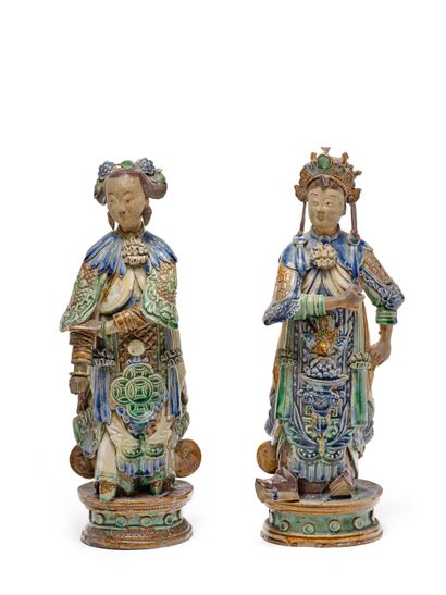 null Vietnam, circa 1900 
Two three-color glazed terracotta statuettes, representing...