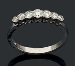 null Bague rivière en or gris 18K (750) sertie de sept diamants taillés en brillant.
Tour...