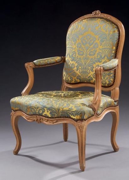 null Fauteuil en noyer mouluré et sculpté à décor de fleurettes et feuillages stylisés;...