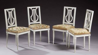 null Suite de quatre chaises en hêtre mouluré, sculpté et relaqué crème; les assises...