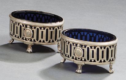 null Pair of oval silver table salt dishes, decorated with medallions, resting on...