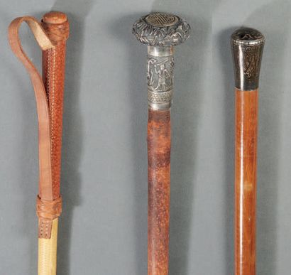 null A cane and two whisks, two of which have knobs in chased and nielloed silver.
Length:...