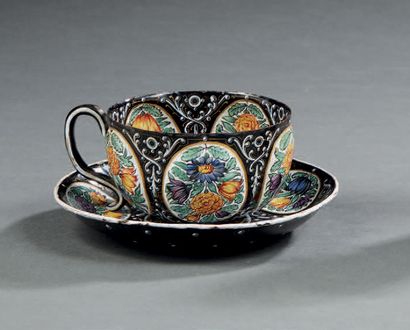 null Cup and its enamelled copper saucer decorated with relief reserves of flowers...