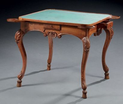 null Walnut game table moulded and carved in walnut with stylized shells; quadrangular...