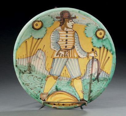 MONTELUPO Circular earthenware dish decorated in polychrome with a character in a...