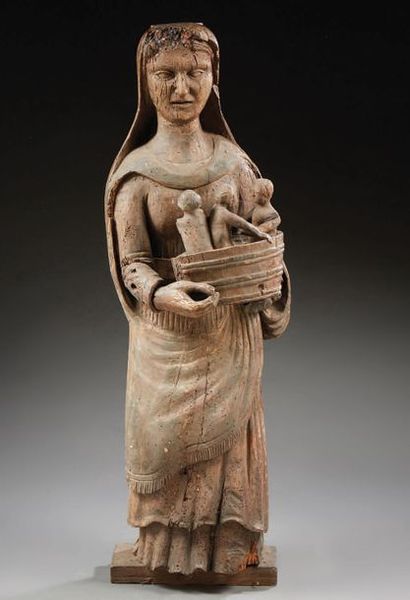 null Statue en tilleul sculpté représentant une Sainte portant dans ses bras un baquet...
