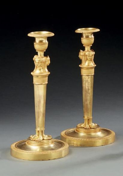 null Pair of candlesticks in chased, knurled or gilded bronze; the bobèches and binets...