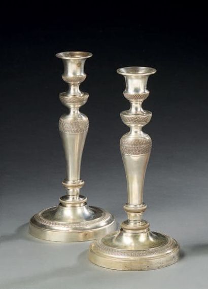 null Pair of candlesticks in knurled and silvered bronze with crosspieces and rosettes...