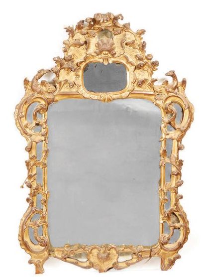 null Mirror in a carved and gilded wooden frame with oak foliage, birds... the pediment...