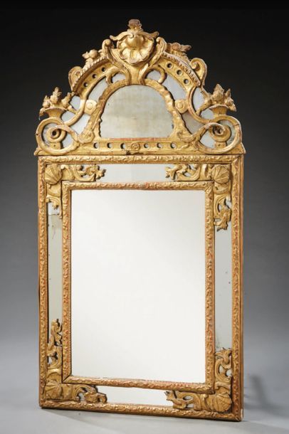 null Mercury mirror in a frame with glazing beads with stylized shell spandrels and...