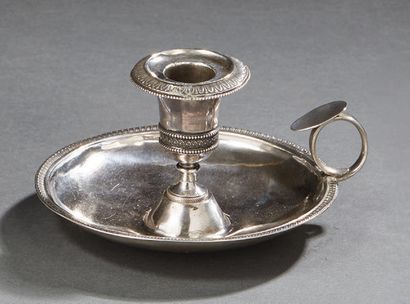 null Hand candleholder and its silver bobpiece, candle surrounded by a Greek frieze,...