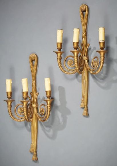 null Pair of sconces in chased and gilded bronze; the drums in ribbons with trimmed...