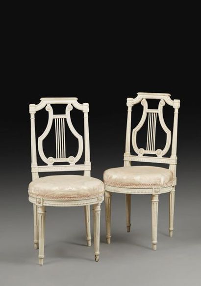 null Pair of chairs in beech moulded, carved and cream lacquered; flat backrests...