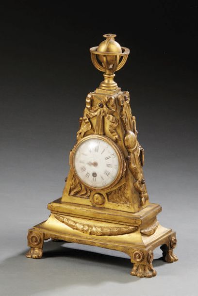 null A chased and gilded bronze clock; the damping decorated with an armillary sphere;...