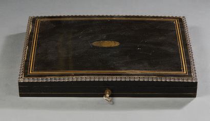 null Case in blackened pearwood and brass fillets; rectangular in shape, the slightly...