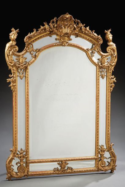 null Mirror with wooden or gilded stucco glazing beads decorated with large shells...
