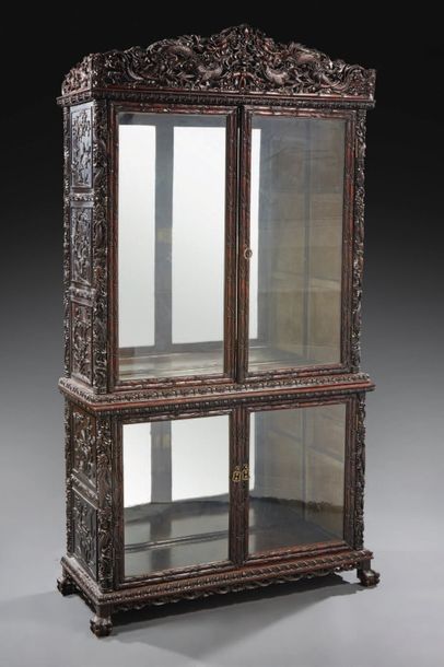 null A library display case in patinated natural wood with a rich carved decoration...