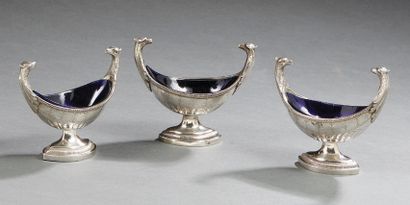 null A series of three silver salt shakers, in the form of a shuttle on a pedestal,...