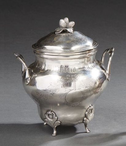 null Sugar bowl and its silver cover, resting on four feet with foliage wraps, the...