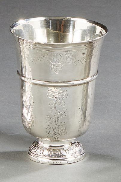 null A large silver tulip timbale resting on an egg-shaped base, surrounded by a...
