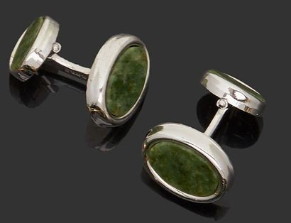 null Pair of gilded metal cufflinks with oval motifs applied with green hard stone...