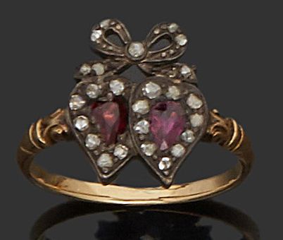 null Wedding ring in 18K (750) gold and silver adorned with two hearts set with garnet.
19th...