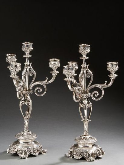 null Pair of candelabra with four silver lights, the base resting on four feet with...