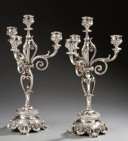 null Pair of candelabra with four silver lights, the base resting on four feet with...