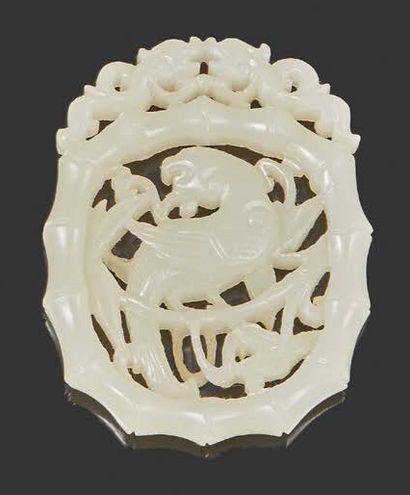 CHINE Pendant in celadon nephrite openwork of a peacock in bamboos.
Size 5 x 4 c...
