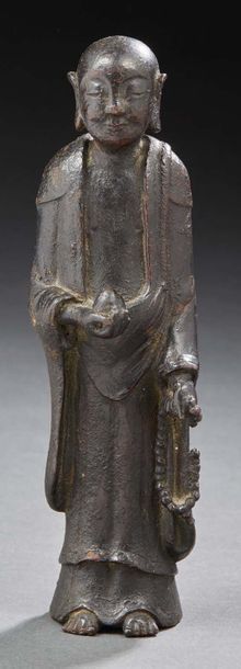 VIETNAM XVIIIe/XIXe siècle Statuette de moine debout en bronze à patine brune, tenant...