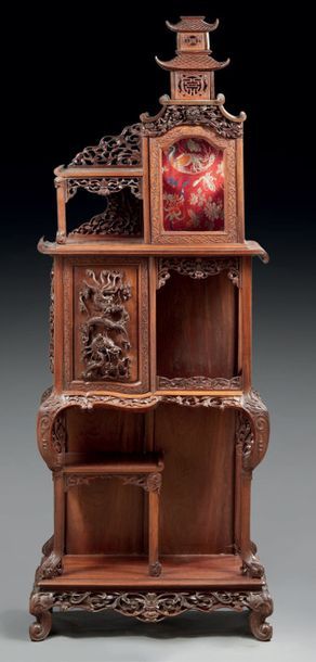 INDOCHINE - Vers 1900 Carved wooden shelf unit, topped with a pagoda, the doors decorated...