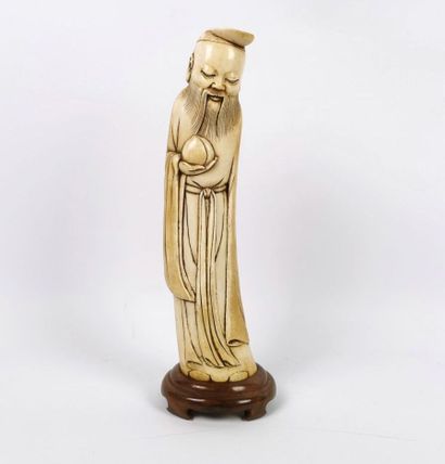 null CHINA, in the Ming style.

Statuette of a wise man in carved ivory, holding...