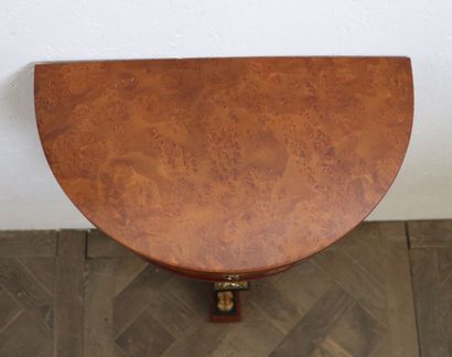 null A small half-moon console in veneer, opening to a drawer in the belt.

The upright...