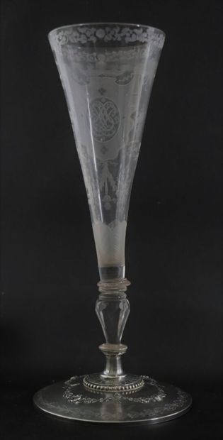 null A glass truncated cone bowl on a foot, engraved with a monogram surmounted by...