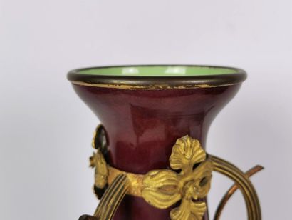 null A pair of burgundy enamelled porcelain vases in a gilt bronze frame.

Art Nouveau...