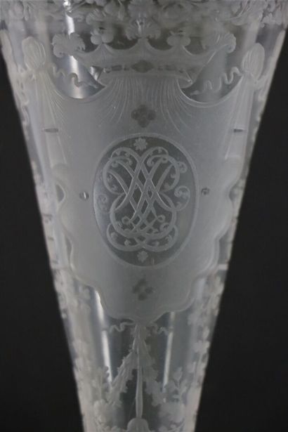 null A glass truncated cone bowl on a foot, engraved with a monogram surmounted by...