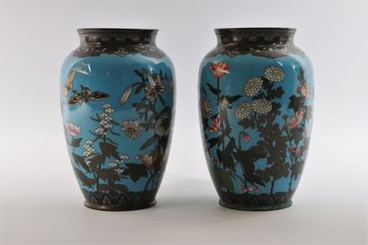 null JAPAN. 

A pair of cloisonné vases decorated with flowers and butterflies on...