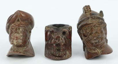 null Collection of nine wooden pipe stoves carved with animals and characters.

L_7...
